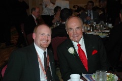 Mark Fleming sitting with Dick Enberg at the 2012 Academic All-America Hall of Fame Induction Ceremony and dinner in St. Louis.